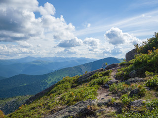 Mountain path in Ergaki Nature Park. Sunny summer day in the mountains of the Western Sayan