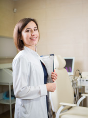 Fototapeta premium Young cute medic girl in a medical room. Medical profession