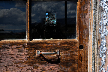 Old weathered door with faded decal