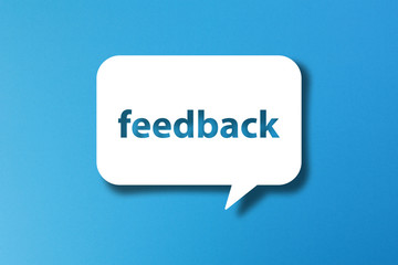 Feedback word with speech bubble on blue background