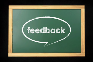 Feedback word with speech bubble on chalkboard background