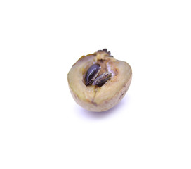 Sapota fruit cut into pieces and seeds in white background