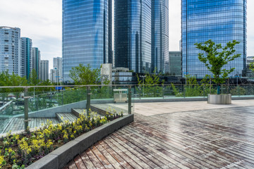 Empty wooden footpath front modern building.