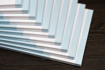 Stack of books with a blue hard cover on wooden background. Composition from books