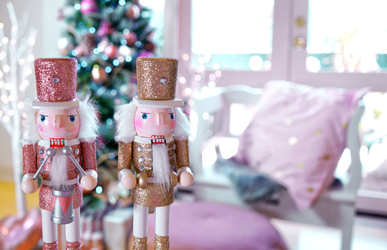 On trend pink and rose gold trimmed Christmas tree with tray of cookies and hot chocolate for Santa, close up on nutcrackers.