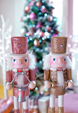 On trend pink and rose gold trimmed Christmas tree with tray of cookies and hot chocolate for Santa, close up on nutcrackers.