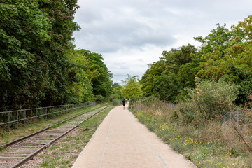 Paris, France: Man running on the old railways ring of the Petite Ceinture, transformed as a promenade area.