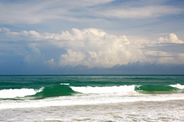 Waves, surf, and the blue sky over the sea, Karon sandy beach on a sunny day, Thailand