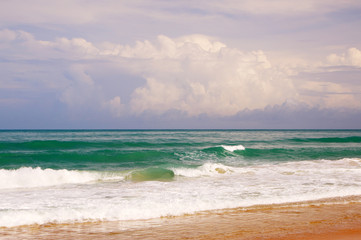 Waves, surf, and the blue sky over the sea, Karon sandy beach on a sunny day, Thailand