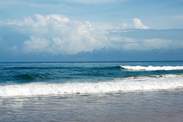 Waves, surf, and the blue sky over the sea, Karon sandy beach on a sunny day, Thailand