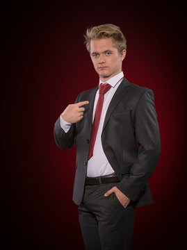 Proud young business man in businesslike suit and tie