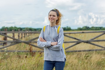 Teenage girl with crossed arms, girl on nature rustic style