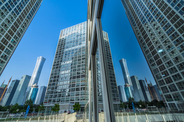 Fototapeta premium Buildings reflected in windows of modern office building