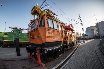 vintage yellow locomotive on a steam train stands at the railway station