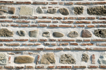 Colorful ancient stone wall close up
