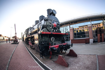 vintage black steam locomotive at the railway station