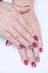 Fototapeta premium Female hands with a beautiful manicure on a white background. Gel polish in a beauty salon