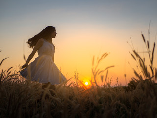 Trendy girl in stylish summer dress feeling free in the field with flowers in sunshine,enjoying nature, Beautiful Teenage Model in the Spring Field, Sun Light. © max_play
