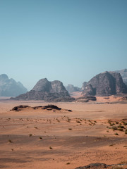 Fototapeta na wymiar Tyre tracks in the desert of Wadi Rum with mountains in the background