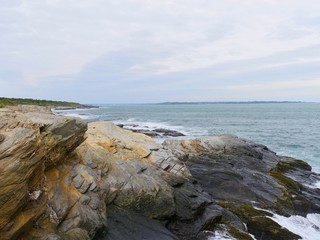 Colored limestone rocks along a coastal road in Jamestown, Rhode Island.