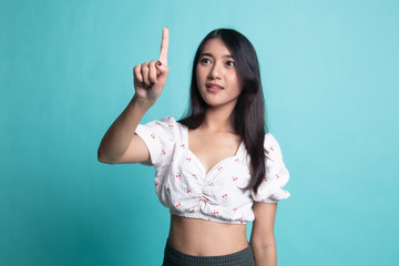 Asian woman touching the screen with finger.