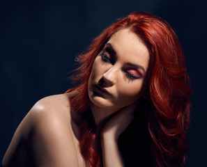 Portrait of beautiful woman with glamour makeup posing with naked shoulders
