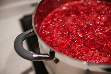 Cooked raspberry jam in a saucepan - obrazy, fototapety, plakaty