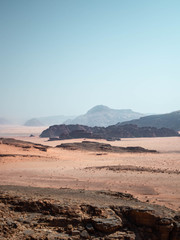 Mountains in the distance of the desert of Wadi Rum from a rocky outcrop