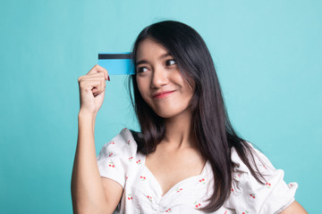 Young Asian woman think with a blank card