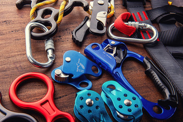 Climbing equipment outdoor for a Mountain trip or Rescue.With rope carabiners ascender belay/rappel device, over concrete background with copy space on wooden background, top view. Travel concept