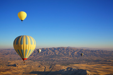Hot air balloon flight in autumn in Cappadocia national Park. Valley of love. Meet the dawn.