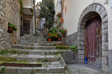 Fototapeta na wymiar Civitanova del Sannio, 11/23/2019. A narrow street among the old houses of a mountain village in the Molise region