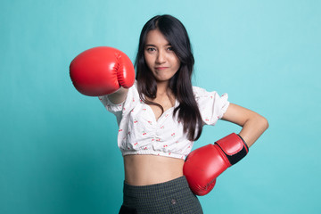 Young Asian woman with red boxing gloves.