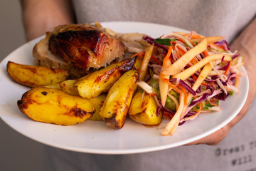baked pork on a plate with salad close-up