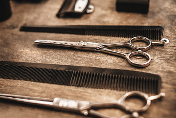 combs and scissors for cutting hair lie on a shelf in a hairdressing salon