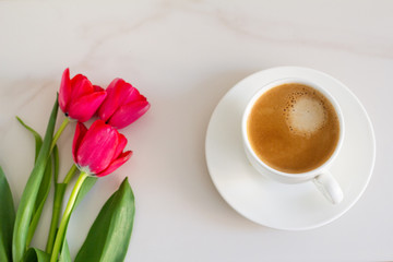 cup of coffee and red tulips