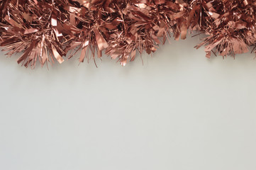 Christmas background with white space for text. Decor with rose gold garland. Wallpaper for the New Year 2020.