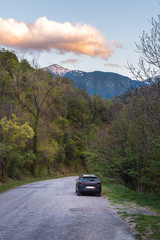 Black car parked on side of mountain road