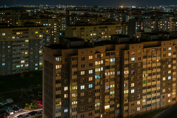 Night panorama of Light in the windows of a multistory building. life in a big city