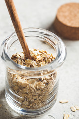 Raw oatmeal in glass jar. Cooking food concept.