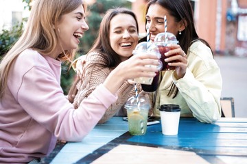 Group Of Friends Drinking Cocktails At Outdoor Bar