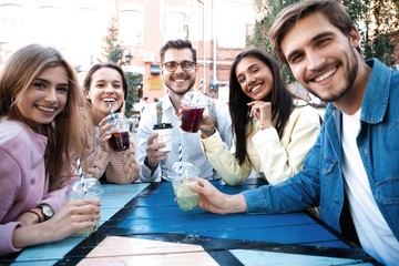 Group Of Friends Drinking Cocktails At Outdoor Bar