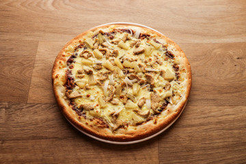 Pizza Hawaii - pineapple pizza on wooden background