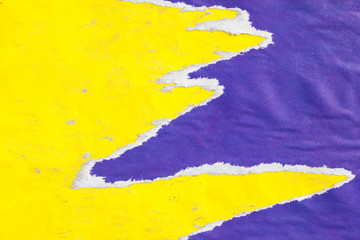 Yellow and purple old crumpled, torn and peeling paper placards with traces of glue texture background.