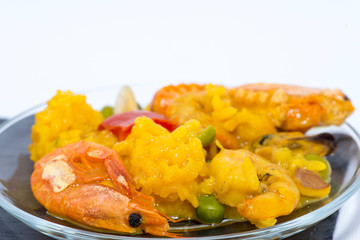 Typical seafood paella from Valencia. Rice with prawns, fish and vegetables