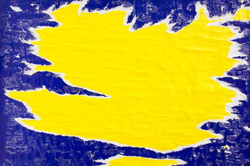 Yellow and blue crumpled, torn and peeling paper posters on billboard with dirty traces of glue...