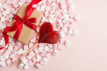 Pink marshmallow hearts and craft gift box on pink background. Sweet background. Top view, copy space. Valentine romance day, mother day, birthday sweetness