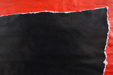 Red and black crumpled, torn and peeling gloss paper placards texture background.