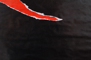 Red and black crumpled, ripped and peeling wavy gloss paper placards texture background.