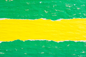 Yellow and green crumpled, ripped and peeling old paper posters and placards texture background....